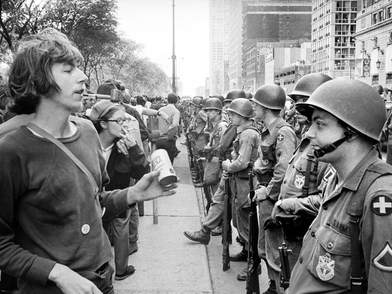 Group of People standing in front of row of National Guard soldiers, across from Hilton Hotel at Grant Park during Democratic National Convention, Chicago, Illinois. Photo by: Universal History Archive/Universal Images Group via Getty Images
