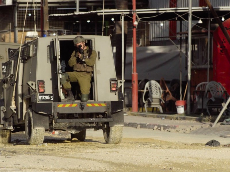 An IDF soldier trains his weapon at the camera during a raid on Nur Shams, West Bank, on April 18, 2024.